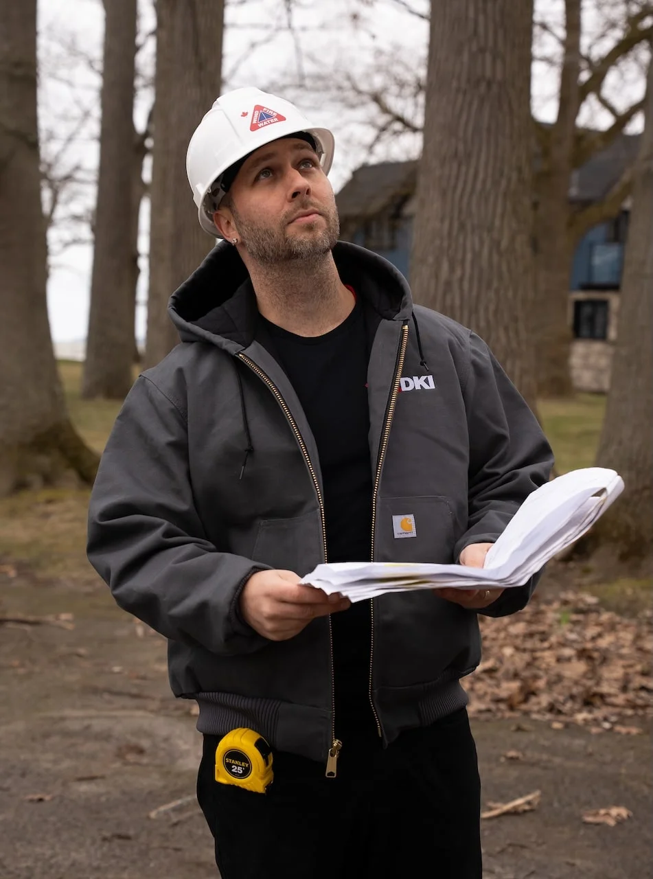 DKI Miller project manager reviewing a repair scope outside a Niagara home