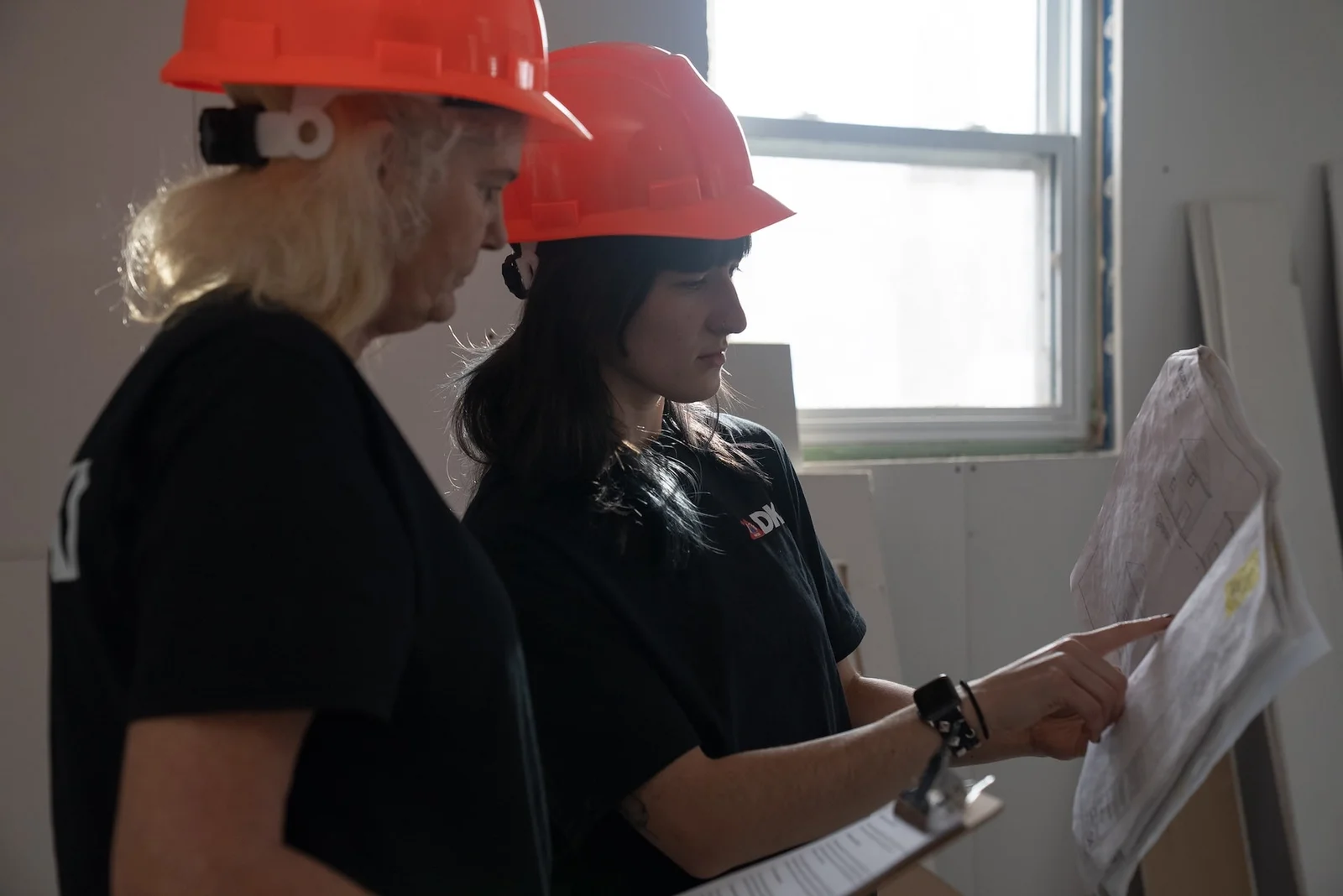 DKI Miller team members reviewing restoration plans on site