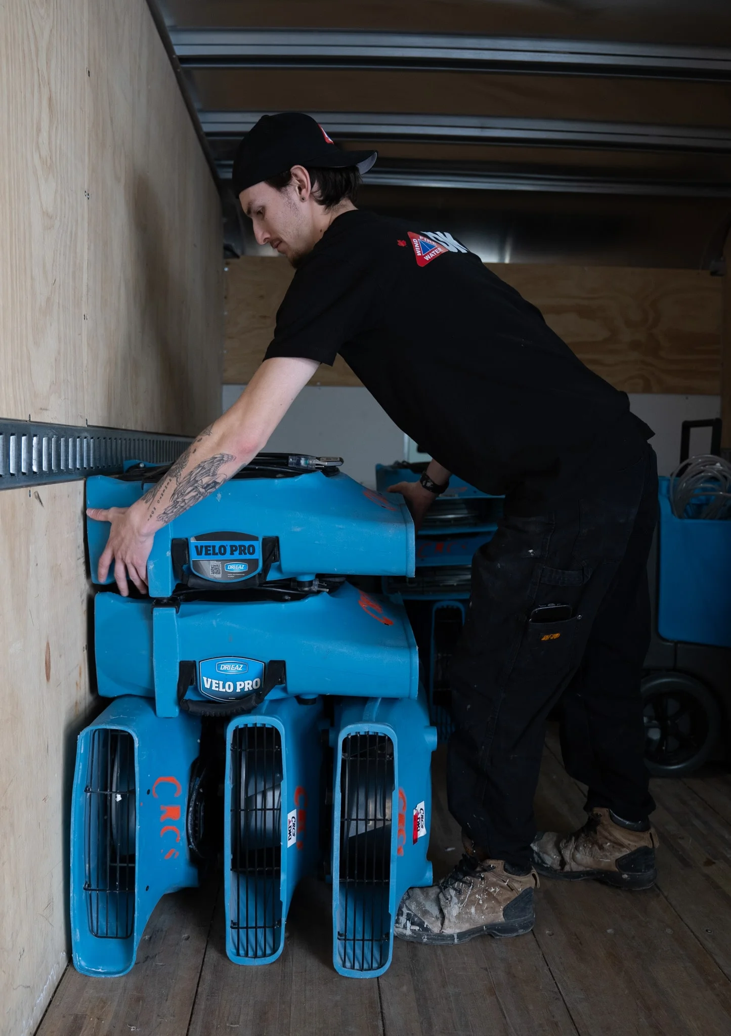 DKI Miller technician loading air movers and dehumidifiers for water damage drying