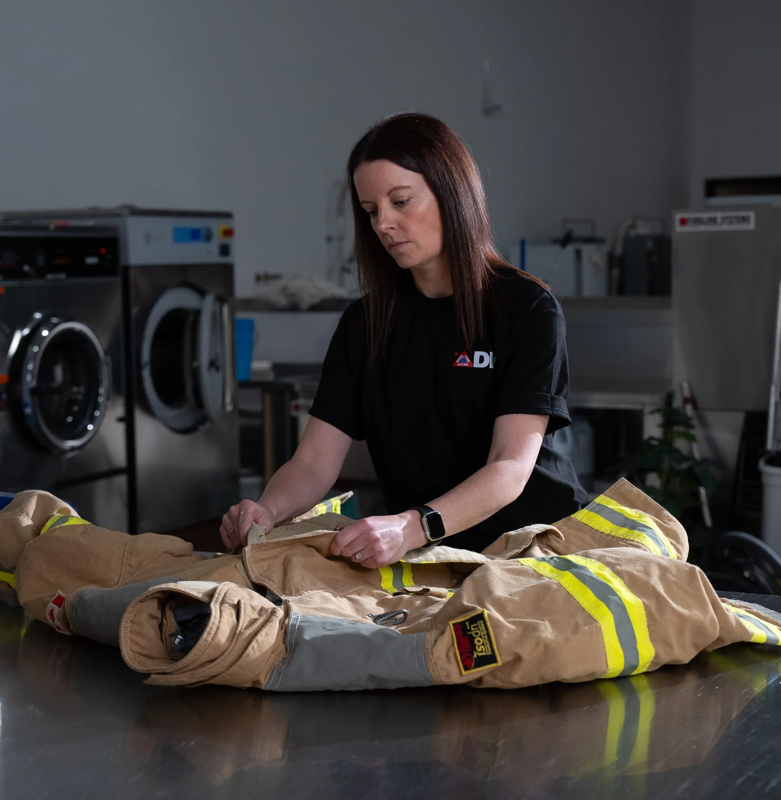 DKI Miller contents technician cleaning and deodorizing smoke-damaged gear